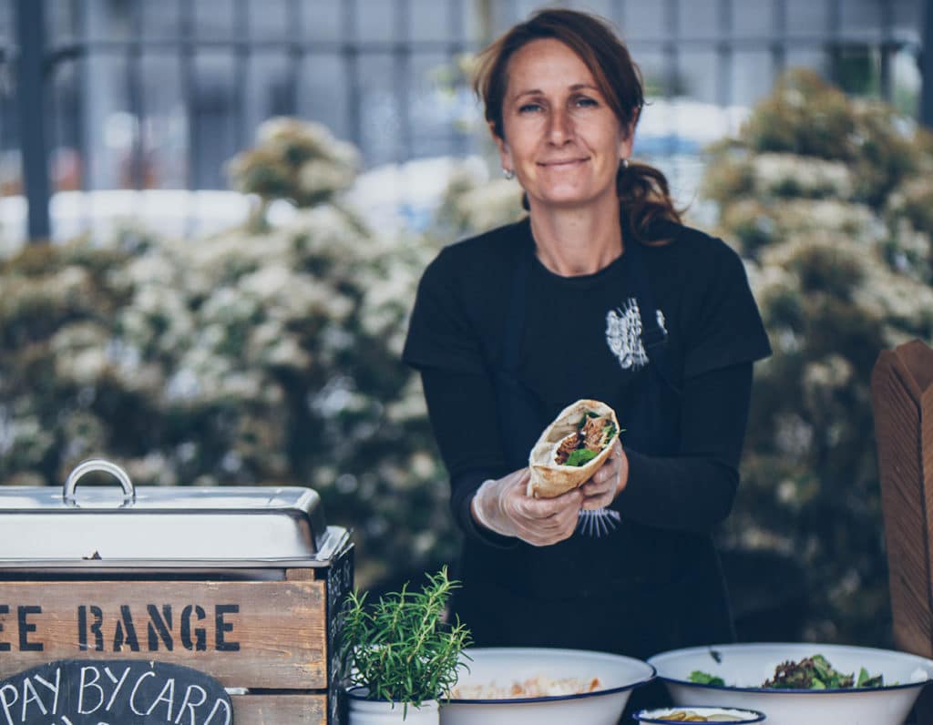 Woman trading at the EAT Festival holding a wrap