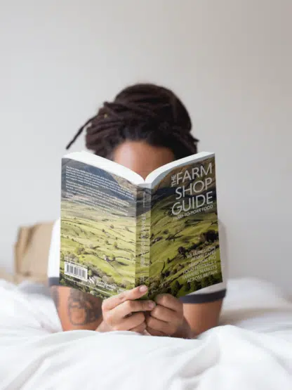 Girl with dreadlocks reading The Farm Shop Guide