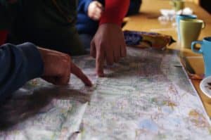 Fingers pointing at a map on a table