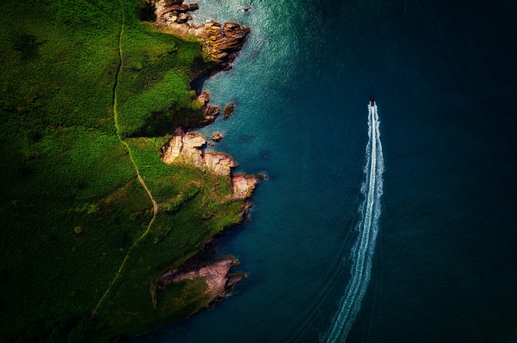 (c) Red Zeppelin, drone shot of the English south coast with cliffs and speedboat