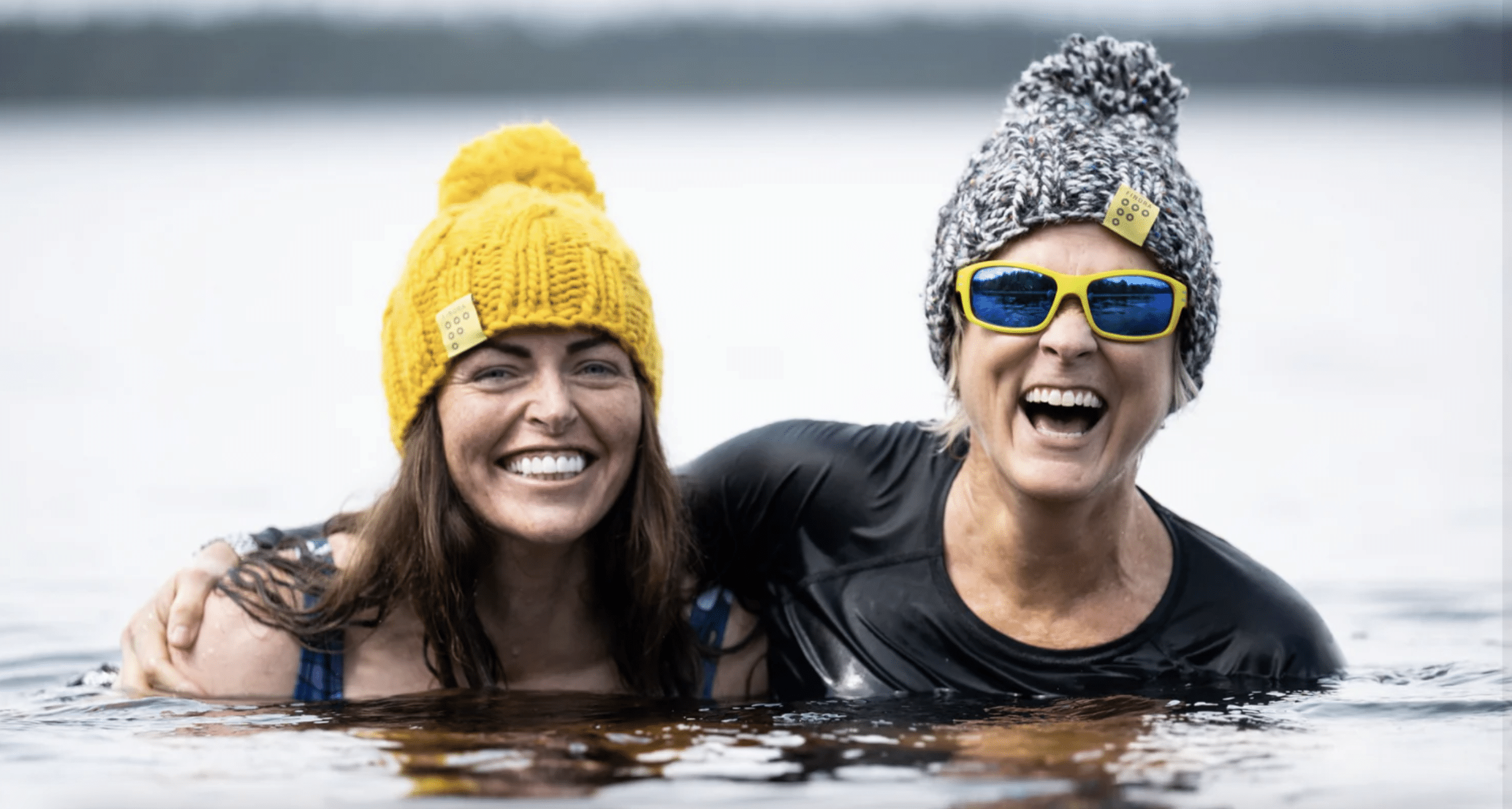 Two women wild swimmers wearing Findra merino wool (c) Findra