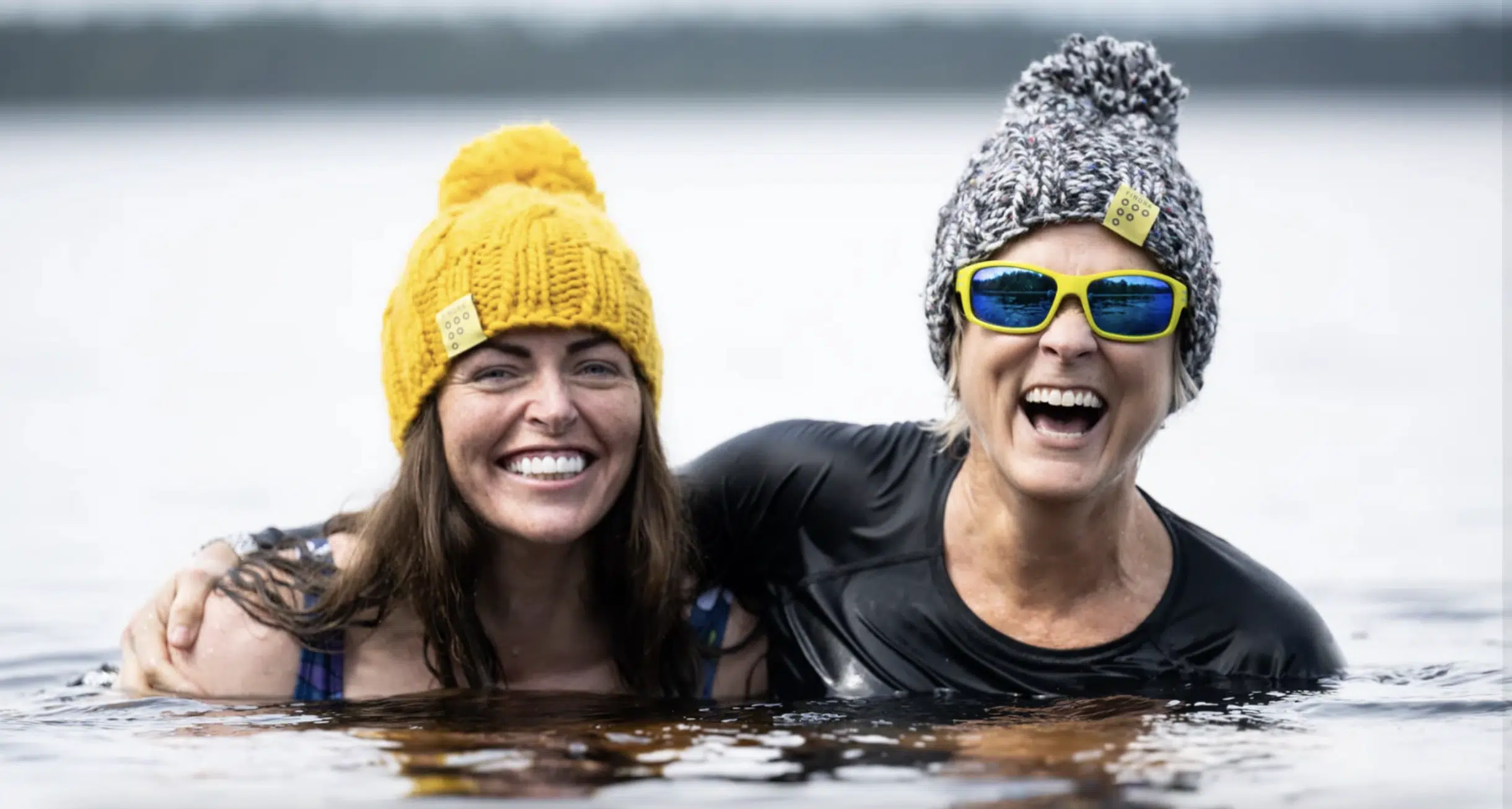 Two women wild swimmers wearing Findra merino wool (c) Findra